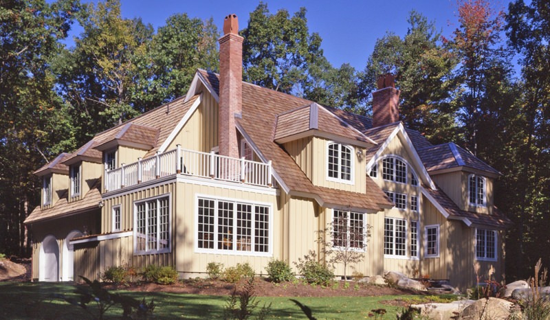 cottage style post and beam home with hipped dormers