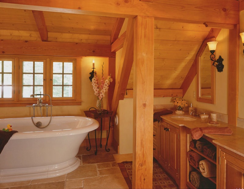 soaking tub in post and beam bathroom under window