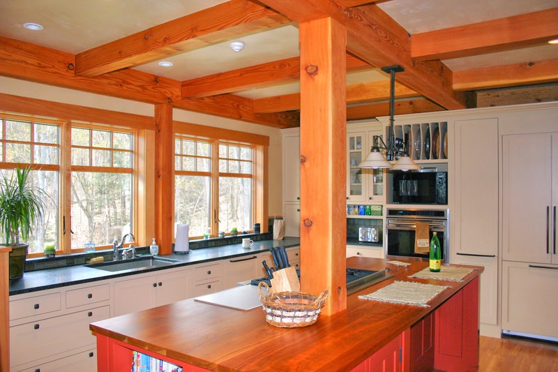 post and beam kitchen with center island and wall of windows