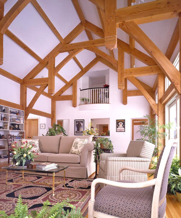 post and beam formal great room with cathedral ceiling