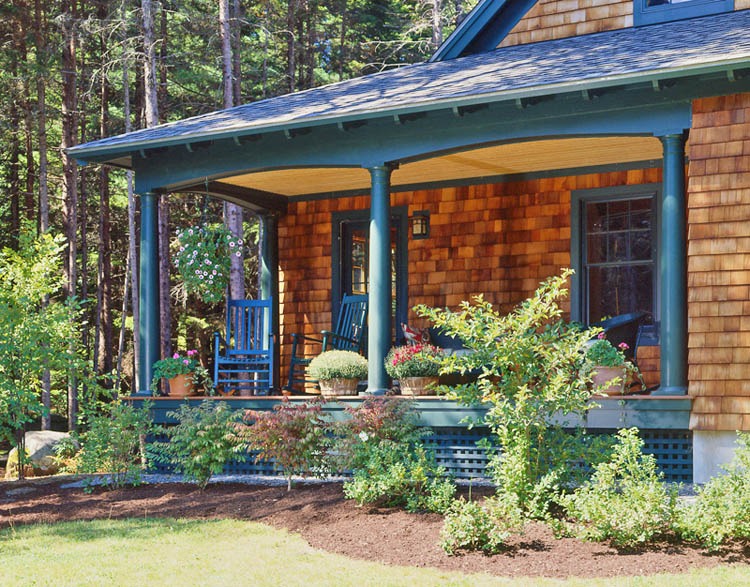 Shingle home Front porch with green rocking chair