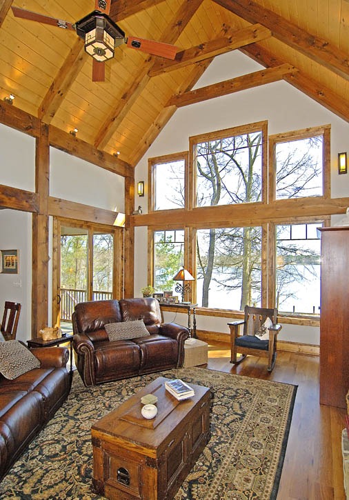 craftsman style post and beam great room with wall of windows