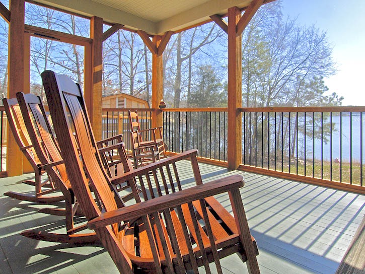 post and beam lake home porch with rocking chairs