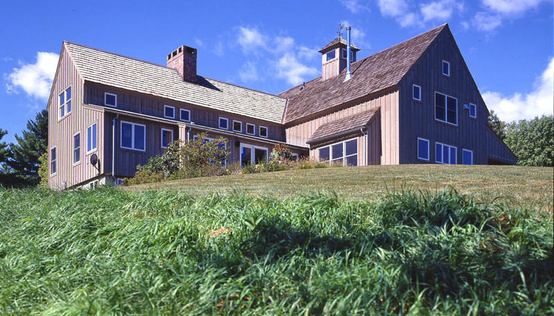 barn home on grassy hill