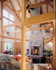 great room with stone fireplace and sunroom attached