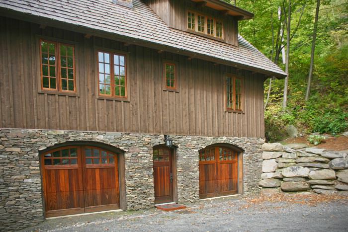 carriage house home with stone foundation
