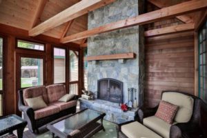 screen porch with stone fireplace