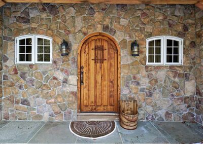 5066 Florence Cottage door surrounded by stone and timber frame