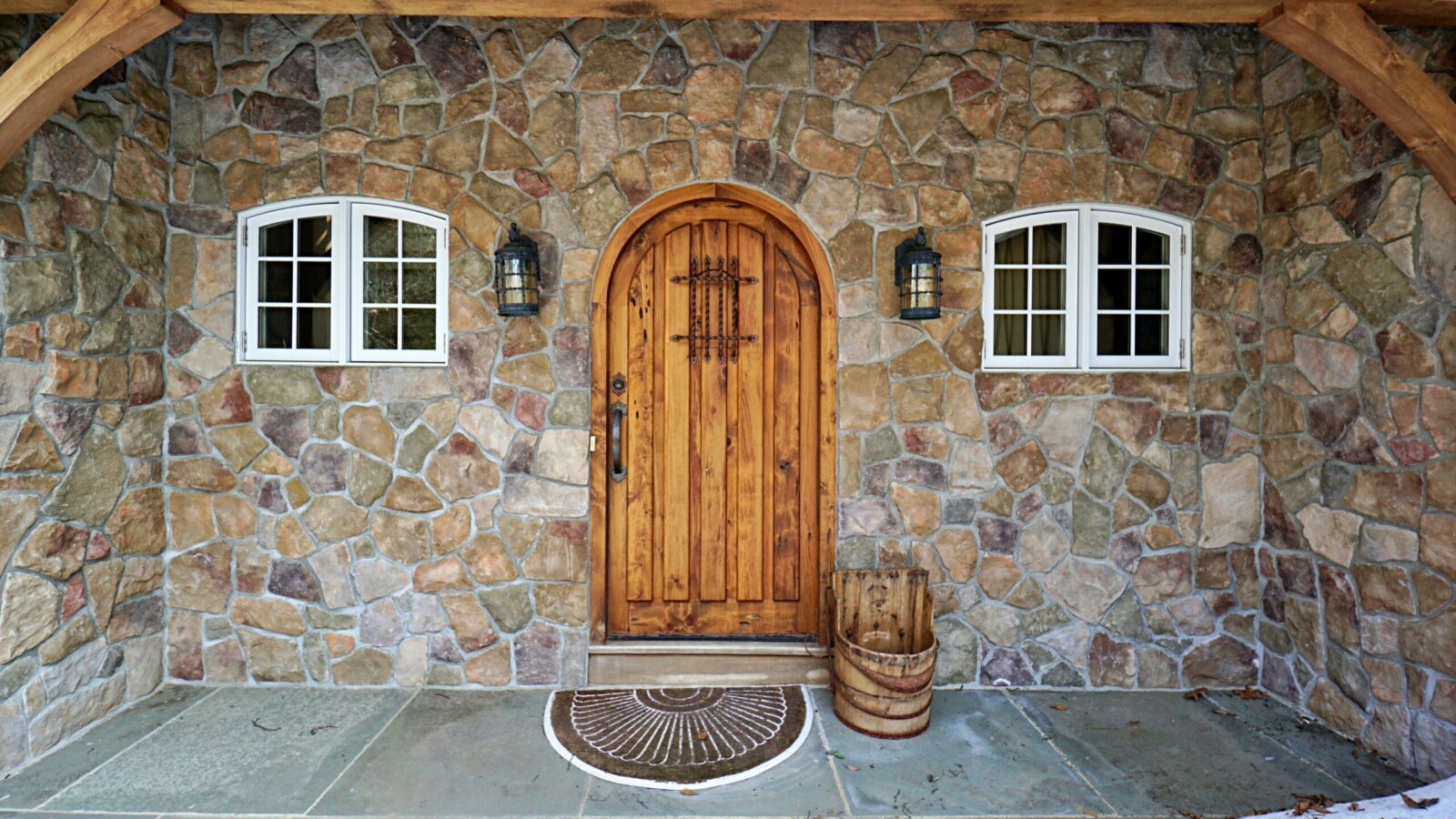 Florence, MA (5066) cottage door surrounded by stone and timber frame