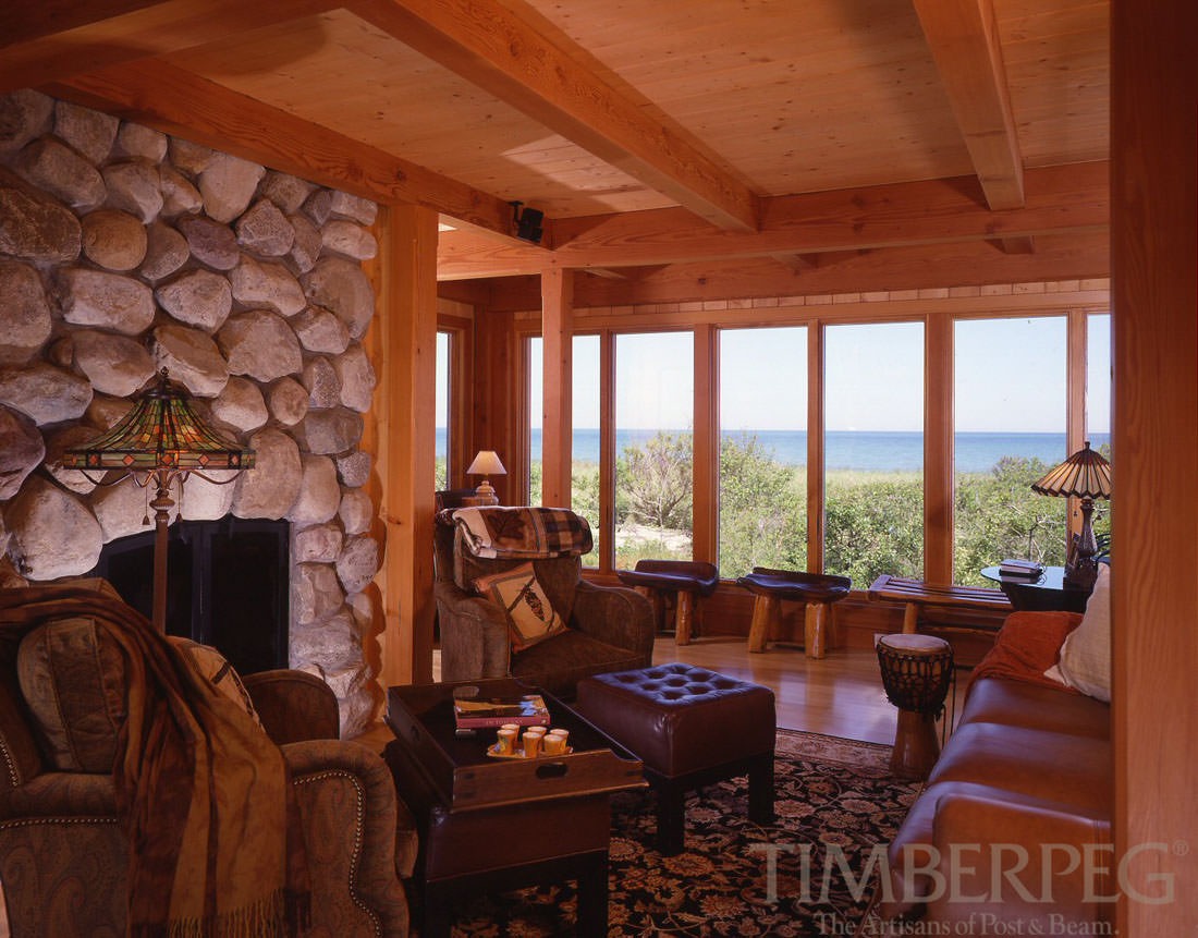 Cape Cod, MA (4647) den with stone fireplace and windows overlooking the water