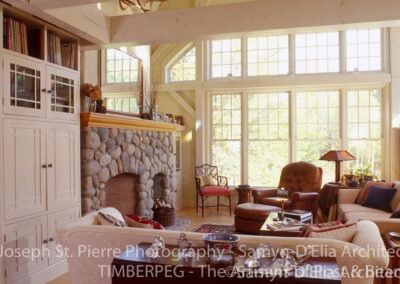 Waterville Valley great room with large window wall and stone fireplace