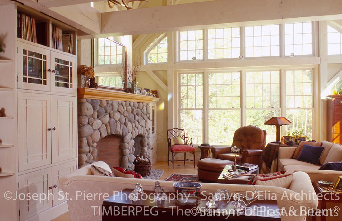 Waterville Valley great room with large window wall and stone fireplace