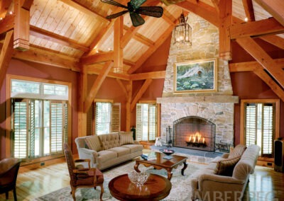 5311 Farmingdale Farmhouse NJ great room with large fireplace, large timber frame and brick red walls