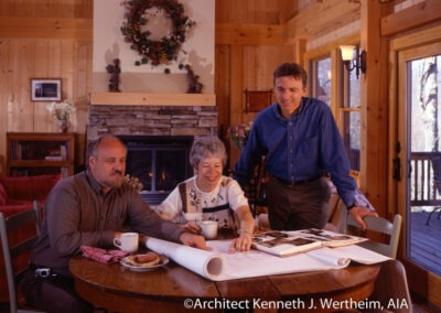 Montreat, NC (5424) owners sitting at table in great room. They are looking at floor plans with arhitect.