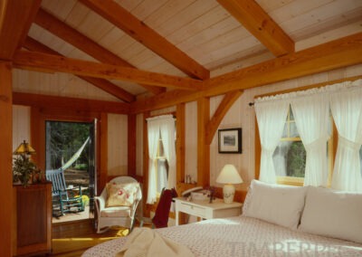 Southwest Harbor, ME (5683) bedroom with timber frame ceiling and open door to patio