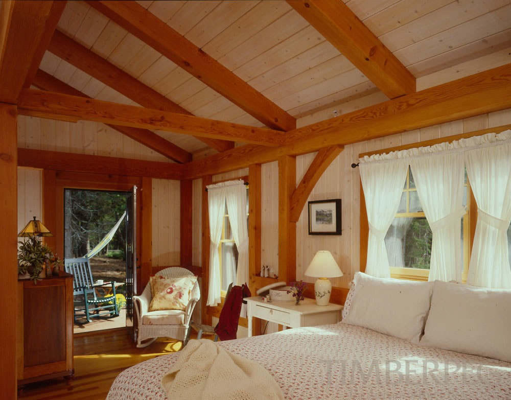 Southwest Harbor, ME (5683) bedroom with timber frame ceiling and open door to patio