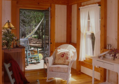 Southwest Harbor, ME (5683) bedroom with timber frame ceiling and door opening to patio