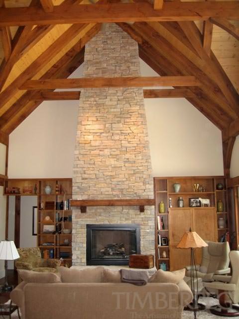 Southeast, WI (T00440) great room with large stone fireplace and timber frame cathedral ceiling