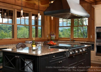 North Country, NH (T00490) kitchen with large island with range, flat top, and hood