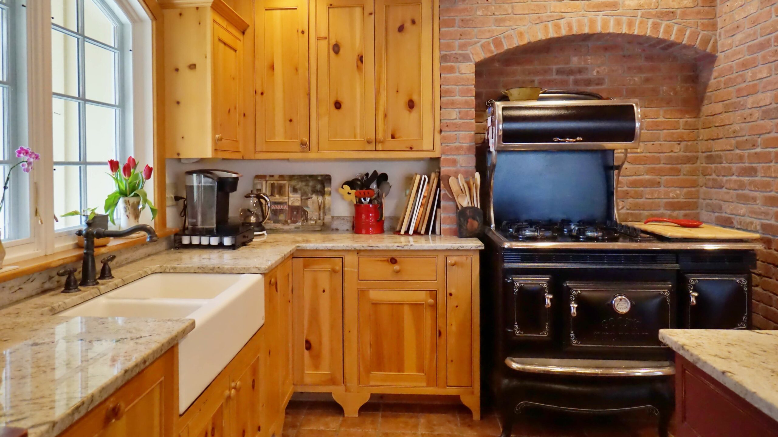 Florence, MA (5066) kitchen with rustic range surrounded by brick