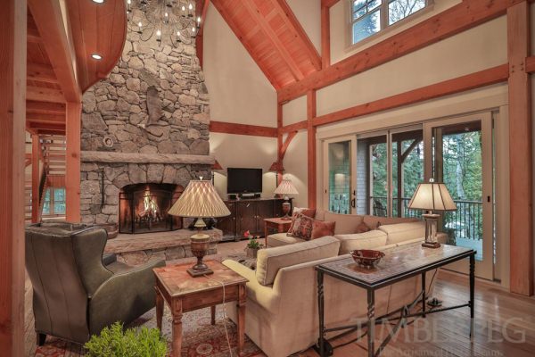 great room with large stone fireplace and small television next to it.