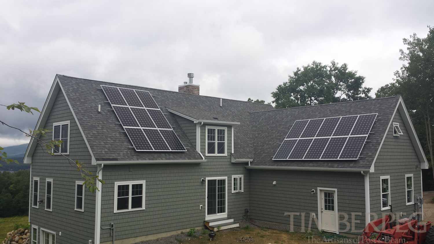 Gilmanton, NH (T00834) exterior view of back of home with solar panels on roof