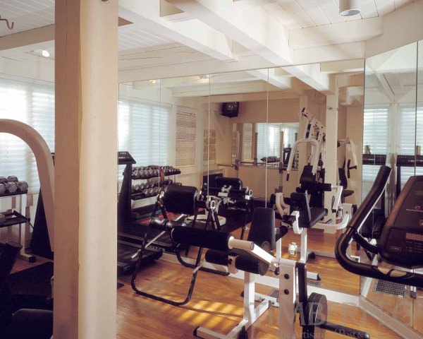 Exercise room with mirrors and heavy training equipment