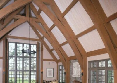 Westport great room featuring large fireplace and cruck trusses