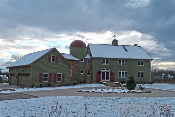Chagrin Falls barn style home with silo. Exterior view with light dusting of snow