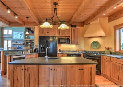 Fairview Cottage (5863) kitchen with wood beams in the ceiling and small island with sink