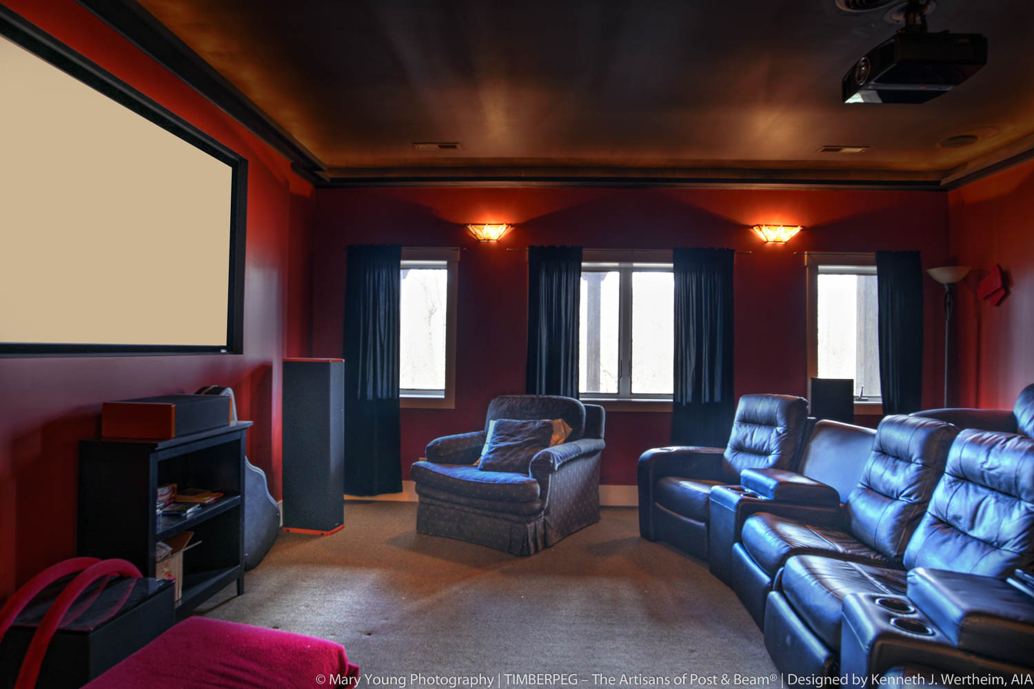 Fairview Cottage NC (5863) home theater featuring leather chairs, dark red walls, and dark curtains