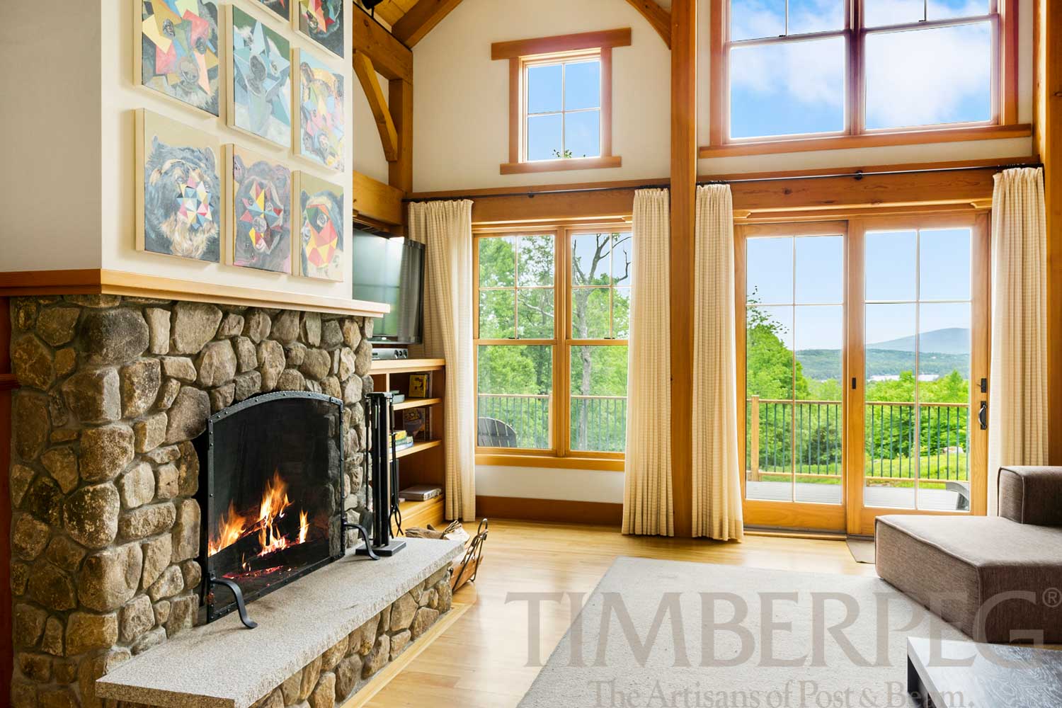 High Ridge, NH (5624) great room featuring stone fireplace and doors out to deck