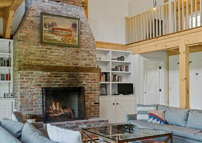 view of great room featuring large brick fireplace