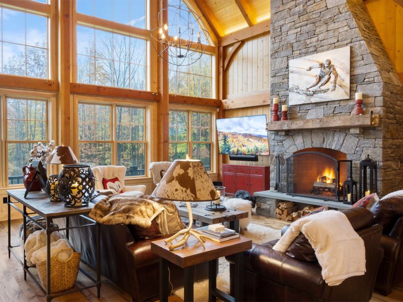 Berkshires great room with large window wall and stone fireplace