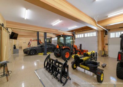 Party Barn and Guest House garage floor with various vehicles and equipment