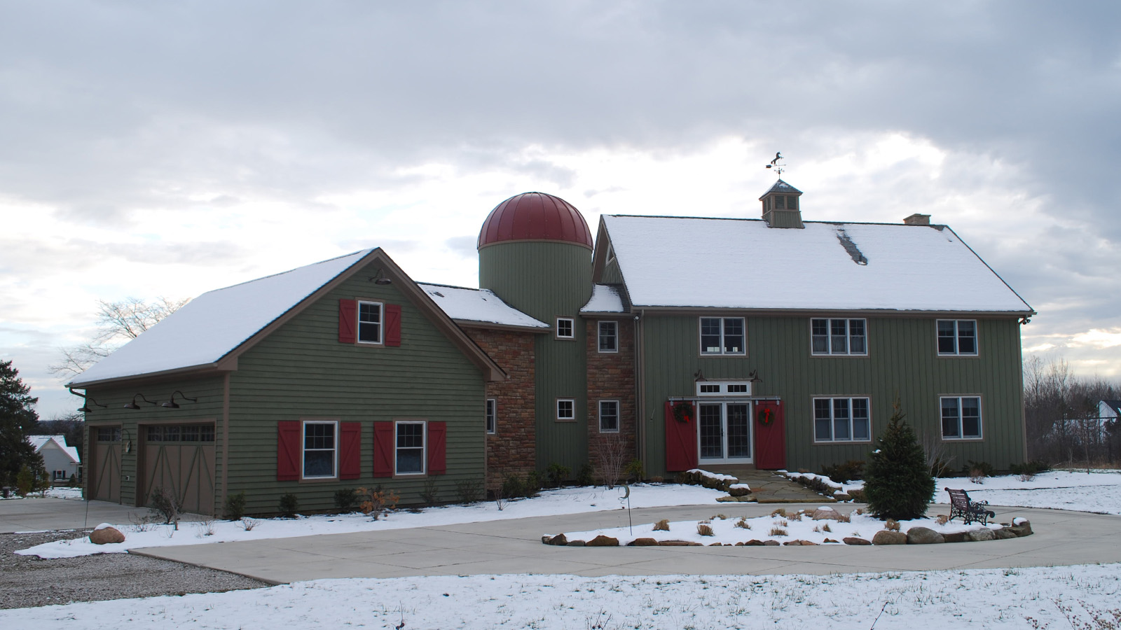 Chagrin Falls, OH Barn Style Home (T00160) exterior view in the snow featuring green home with red trim and shutters