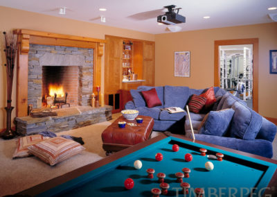 The Ascutney (5719) living room with fire in fireplace, bumper pool table, and projector