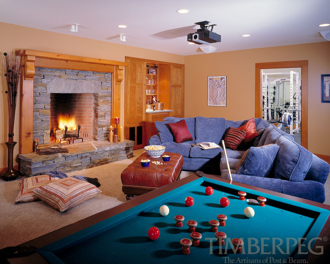 The Ascutney (5719) living room with fire in fireplace, bumper pool table, and projector
