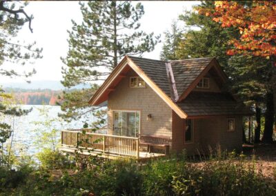 Water's Edge Cottage T00494 exterior view in the fall and looking out over lake nubanusit