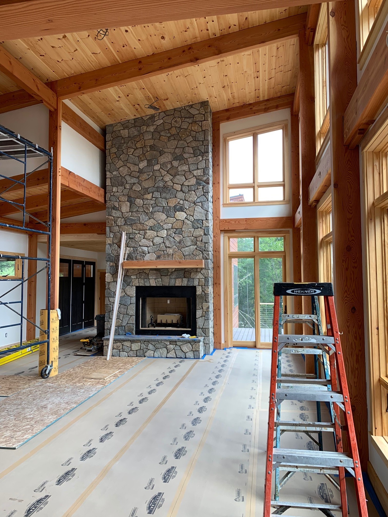 Franconia Mountain Modern T01265 interior construction, featuring stone fireplace
